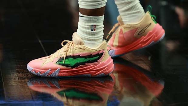 Portland Trail Blazers guard Scoot Henderson's pink and green PUMA shoes.